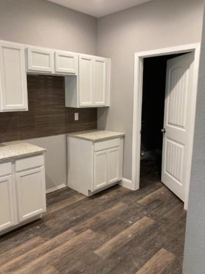 809 South Travis Avenue Denison, TX 75021 - Photo 9 of 13 a kitchen with white cabinets and sink