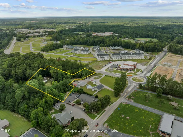 an aerial view of a residential houses with outdoor space and river