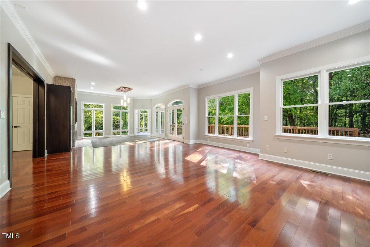 6300 Swallow Cove Lane Raleigh, NC 27614 - Photo 8 of 67 a view of an empty room with wooden floor and a window