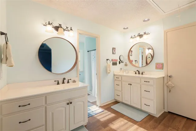 a spacious bathroom with a double vanity sink and a mirror