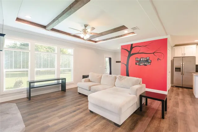 a living room with furniture and a large window