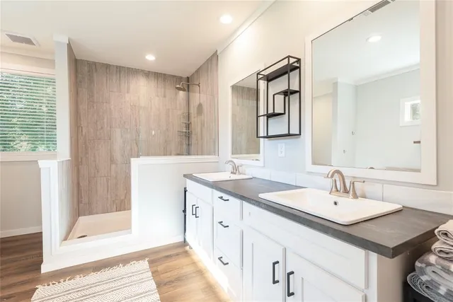 a bathroom with a sink double vanity and a mirror