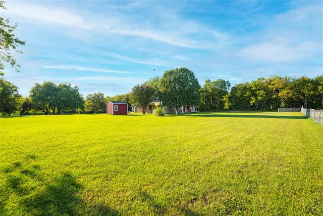 a view of outdoor space with swimming pool and trees in the background