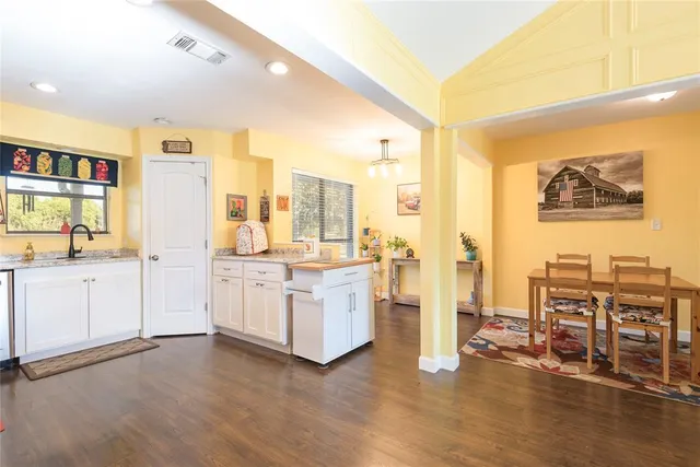 a open kitchen with cabinets and wooden floor