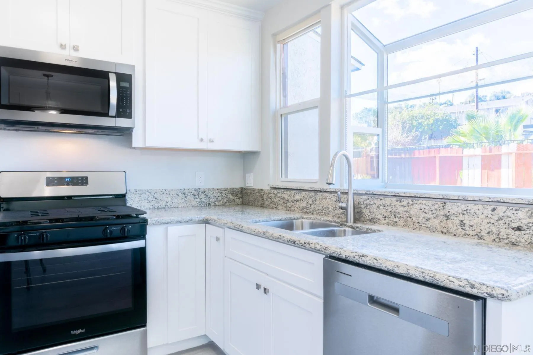 3862 Spring Drive Spring Valley, CA 91977 - Photo 7 of 18 a kitchen with granite countertop a sink and a stove top oven