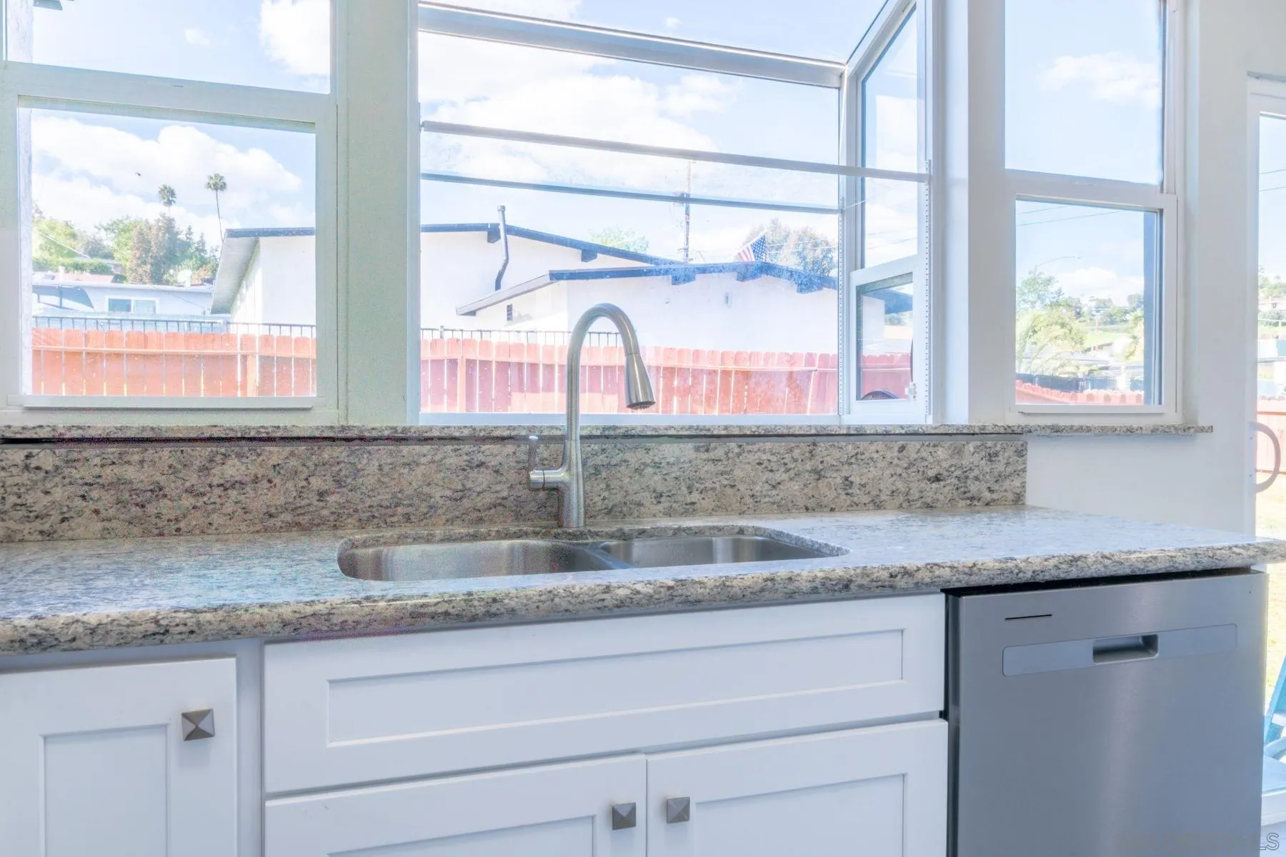 3862 Spring Drive Spring Valley, CA 91977 - Photo 8 of 18 a kitchen with granite countertop white cabinets and a window