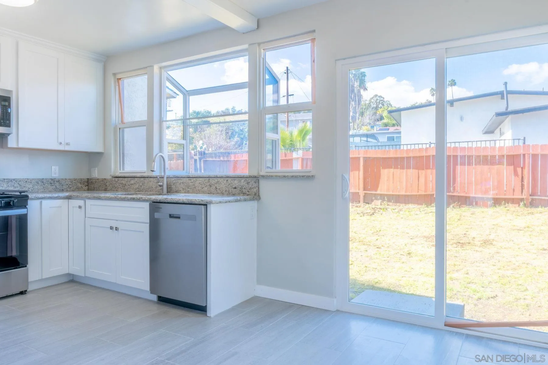3862 Spring Drive Spring Valley, CA 91977 - Photo 9 of 18 a kitchen with a window wooden floor and a sink
