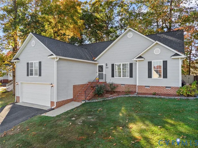 a view of a house with a yard and a porch