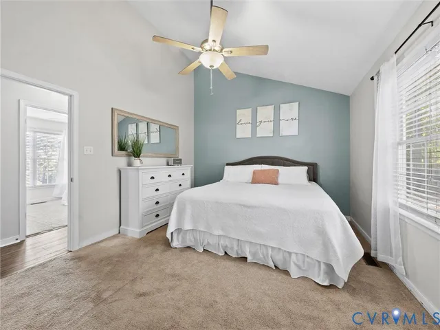 a spacious bedroom with a bed and a chandelier