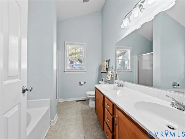 a spacious bathroom with a tub sink and mirror