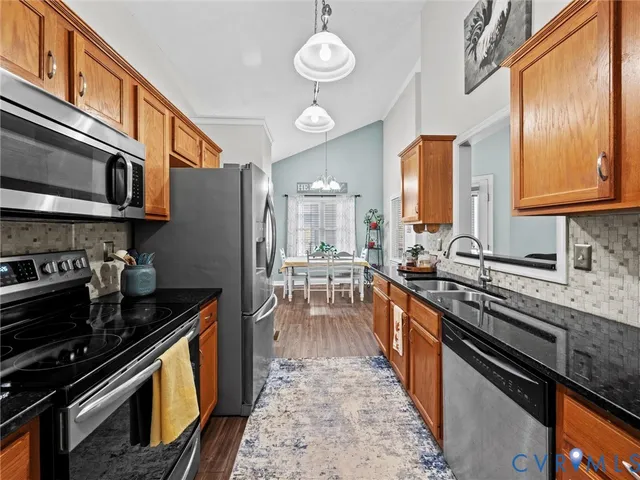 a kitchen with stainless steel appliances granite countertop a stove and a sink