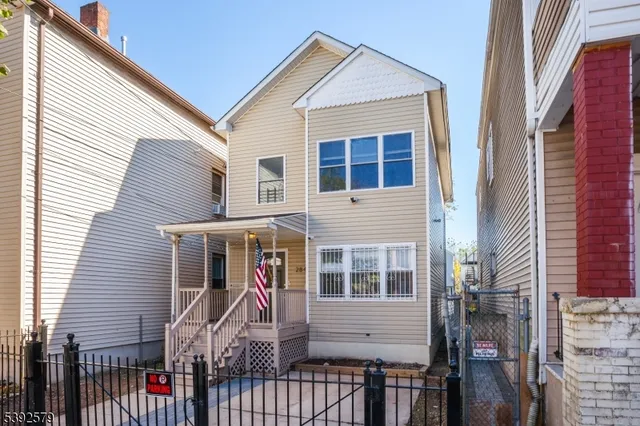 a view of a house with iron fence