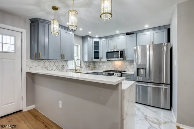 a kitchen with cabinets appliances and a sink