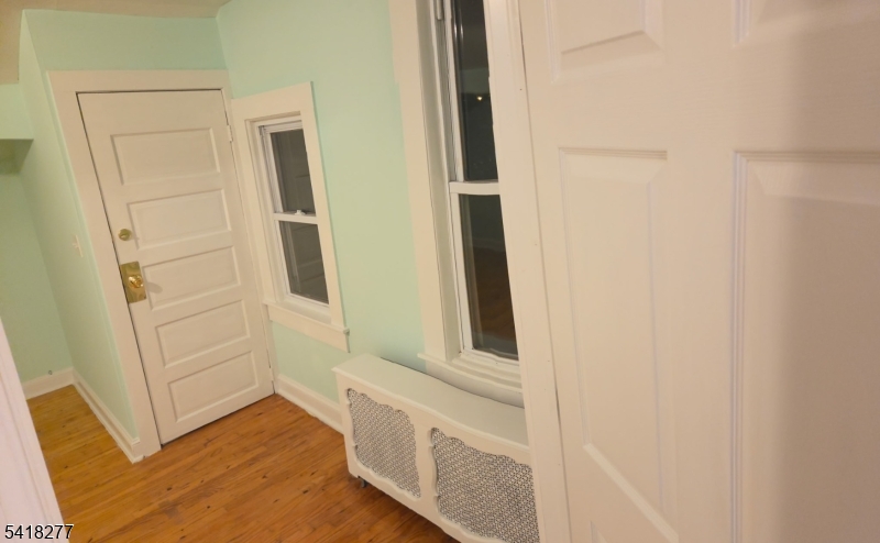 117 Ridgedale Avenue Cedar Knolls, NJ 07927 - Photo 3 of 6 hallway with window and wooden floor