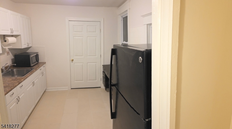 117 Ridgedale Avenue Cedar Knolls, NJ 07927 - Photo 4 of 6 a kitchen with a refrigerator and a stove