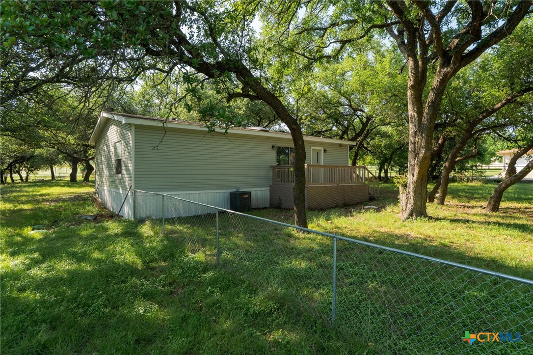 2739 Willow Loop Kempner, TX 76539 - Photo 23 of 30 a backyard with a table and chairs and a large tree