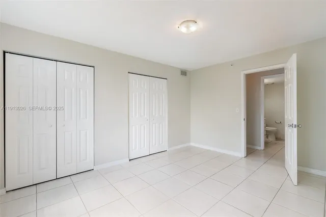 a view of an empty room and closet area