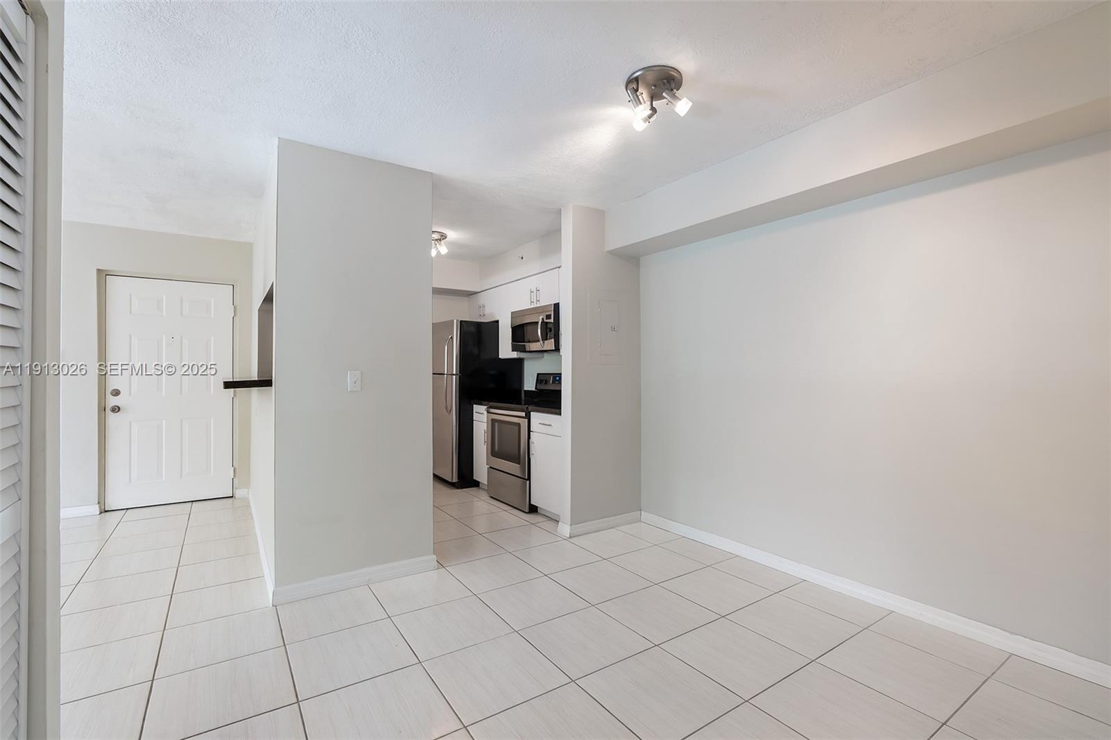 12136 St.Andrews Place, Unit 204 Miramar, FL 33025 - Photo 15 of 21 a view of kitchen with refrigerator cabinets and outdoor space