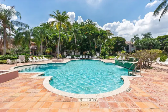 a view of a swimming pool with a yard