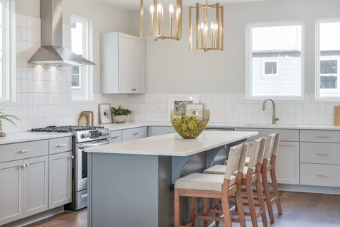 a kitchen with a table chairs and cabinets