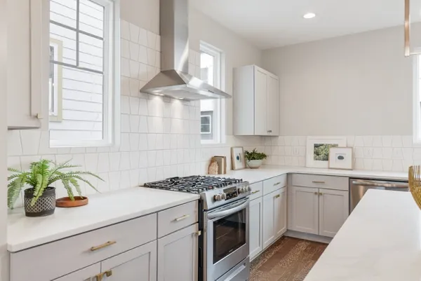 a kitchen with a white cabinets and white appliances