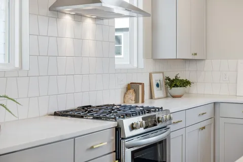 a stove top oven sitting inside of a kitchen
