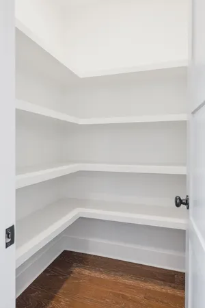 a view of walk in closet with empty racks