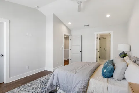 a bedroom with a bed and wooden floor