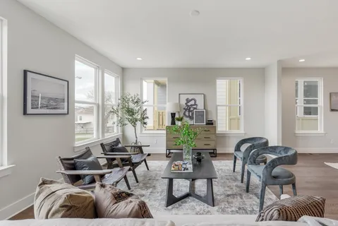 a living room with furniture and a large window