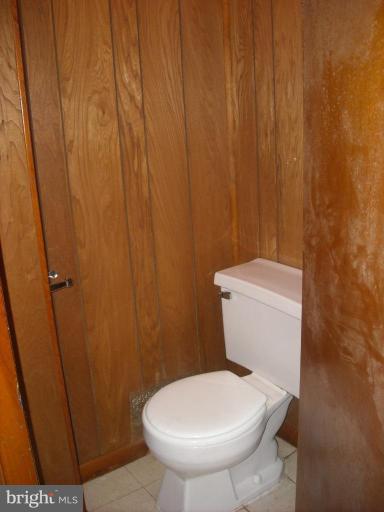 5741 Edgepark Road Baltimore, MD 21239 - Photo 3 of 16 a white toilet sitting next to a shower
