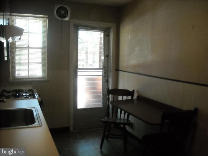 5741 Edgepark Road Baltimore, MD 21239 - Photo 10 of 16 a kitchen that has a sink chair and a window