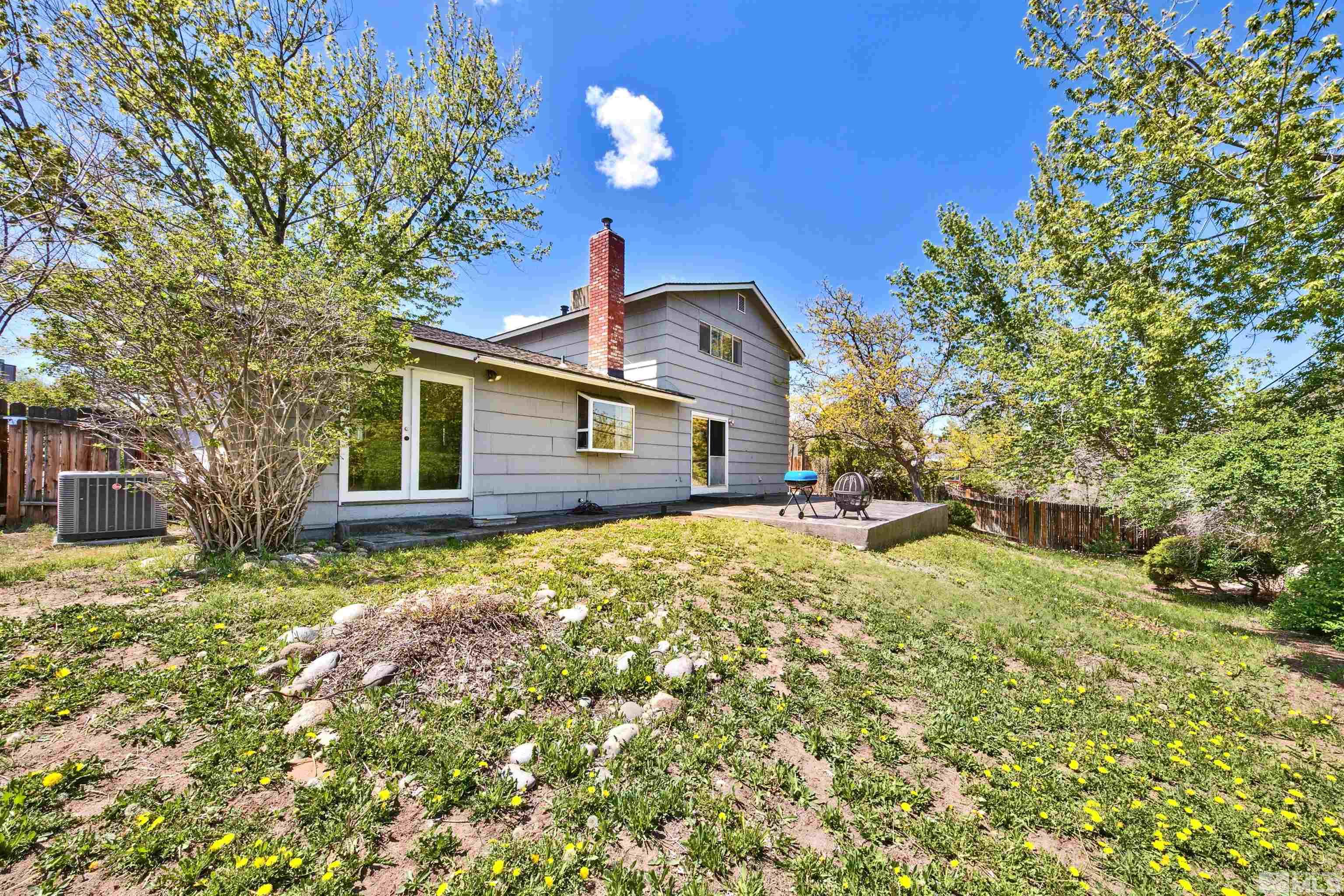 1070 Mark Allen Circle Reno, NV 89503 - Photo 2 of 11 a big yard with table and chairs under an umbrella
