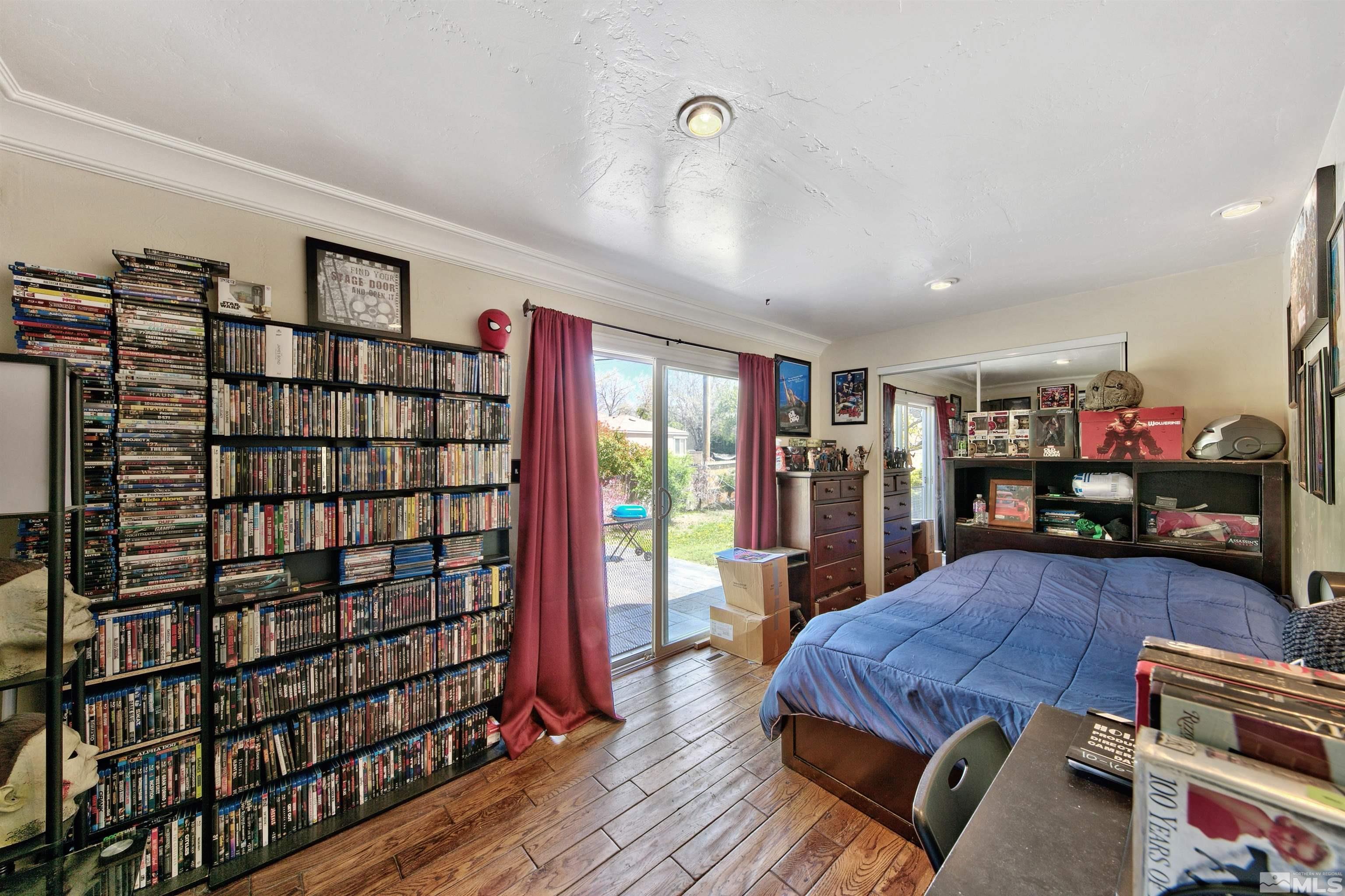 1070 Mark Allen Circle Reno, NV 89503 - Photo 7 of 11 a bed room with a bed and a book shelf