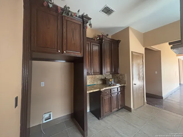 a view of a kitchen with lots of appliances