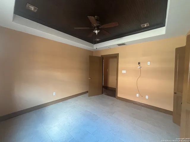 a view of a room with a ceiling fan