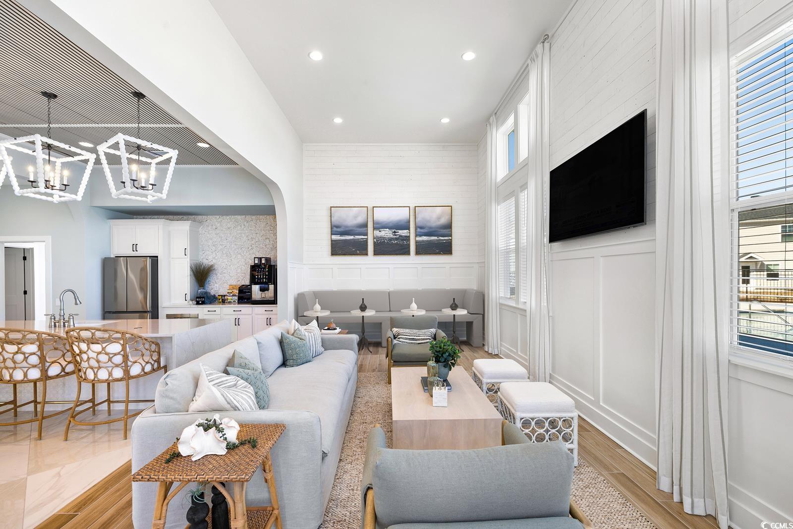283 Ferretti Street, Unit CONCORD Myrtle Beach, SC 29579 - Photo 13 of 34 Living room featuring a chandelier, light wood-style flooring, a decorative wall, and recessed lighting