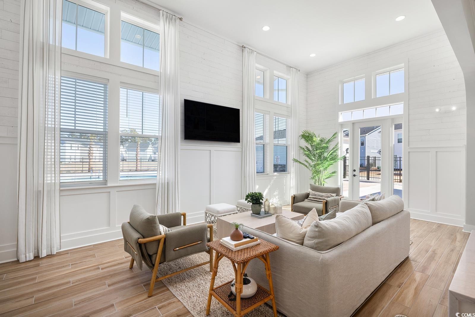 283 Ferretti Street, Unit CONCORD Myrtle Beach, SC 29579 - Photo 14 of 34 Living area featuring a decorative wall, light wood finished floors, a high ceiling, french doors, and recessed lighting