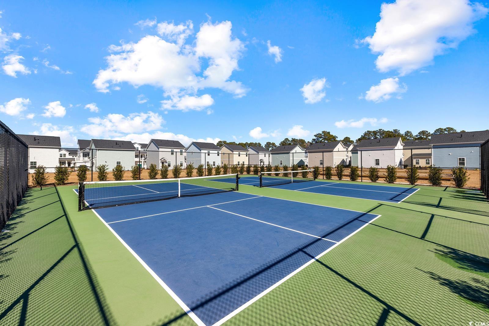 283 Ferretti Street, Unit CONCORD Myrtle Beach, SC 29579 - Photo 17 of 34 View of tennis court featuring a residential view, fence, and community basketball court