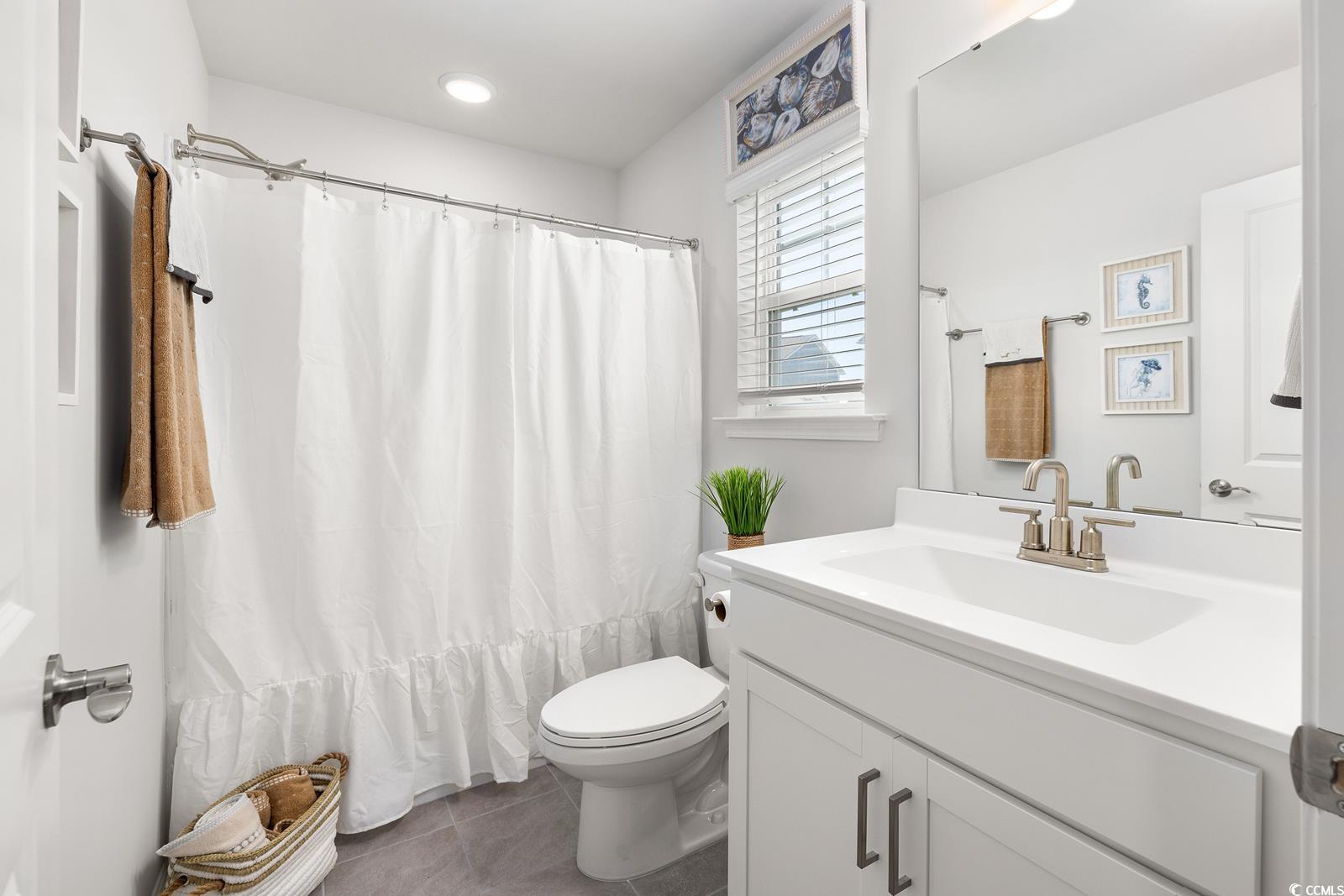283 Ferretti Street, Unit CONCORD Myrtle Beach, SC 29579 - Photo 9 of 34 Full bath featuring tile patterned floors, toilet, vanity, and a shower with curtain