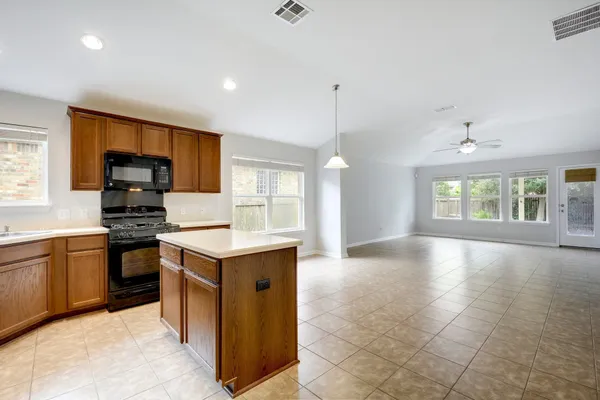 a kitchen with stainless steel appliances granite countertop a stove and a sink