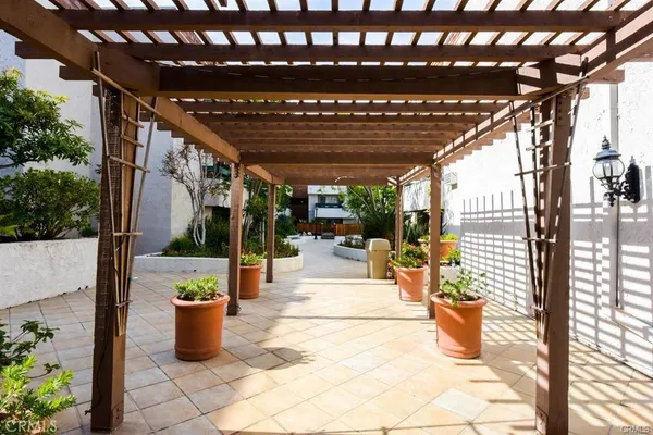 a balcony with wooden floor and potted plants