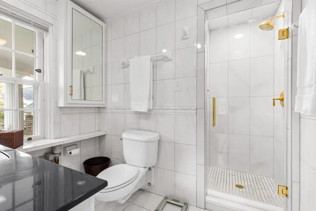 a living room with a bed furniture and a potted plant