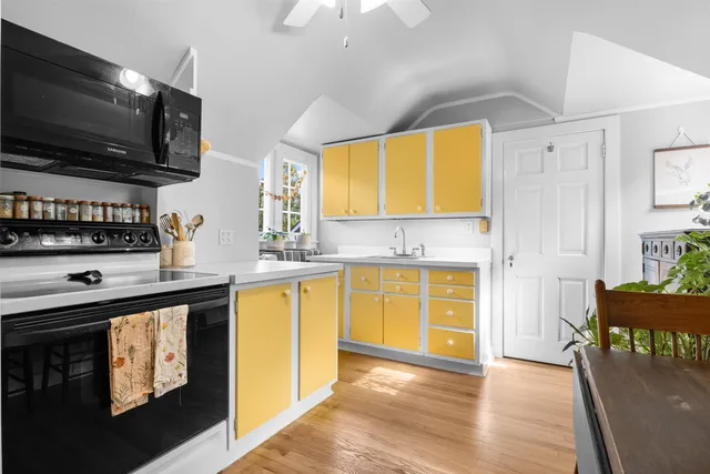 front view of a brick house with a yard