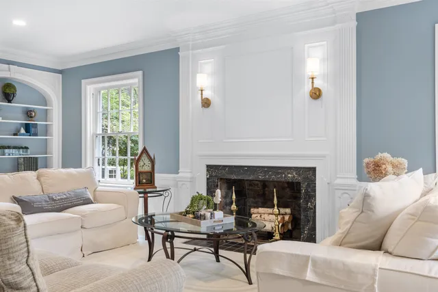 a living room with furniture dining table and a chandelier