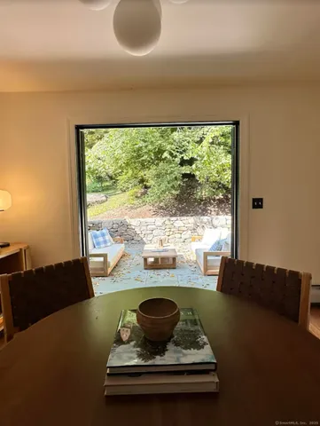 a living room with furniture and a floor to ceiling window