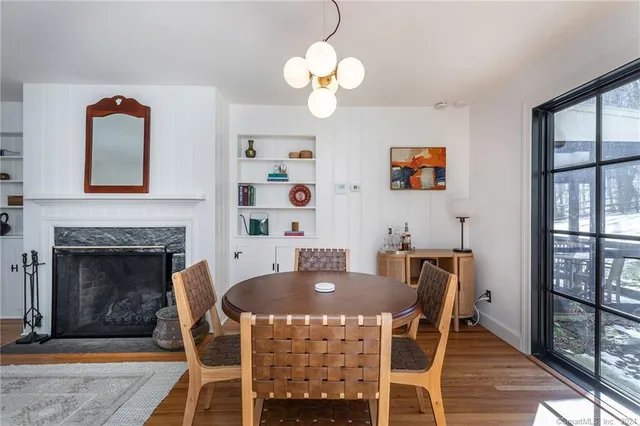 a view of a dining room with furniture wooden floor and a chandelier