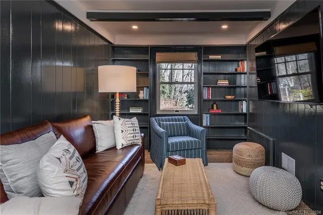 a living room with furniture a rug and a window
