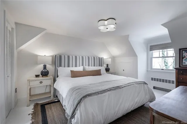 a bedroom with a bed and window