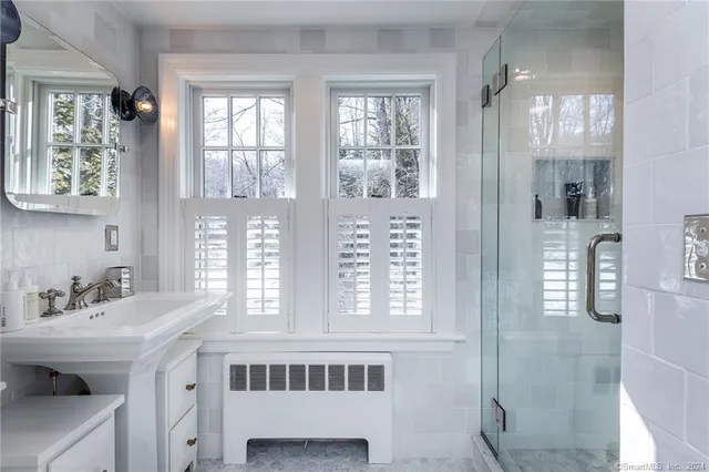 a bathroom with a sink a mirror and a window