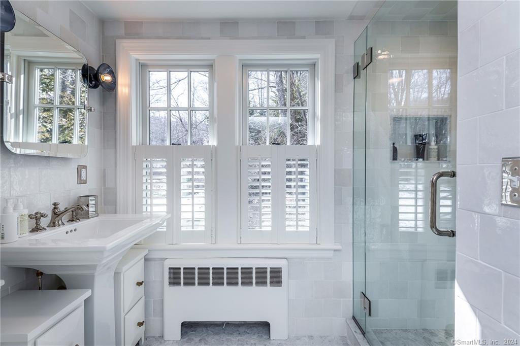23 Cook Street Washington, CT 06794 - Photo 28 of 39 a bathroom with a sink a mirror and a window